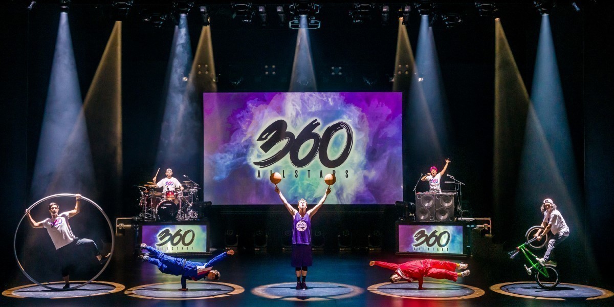 All of the 360 ALLSTARS artists on stage in individual beams of light with 360 logos projected on the screens behind them.