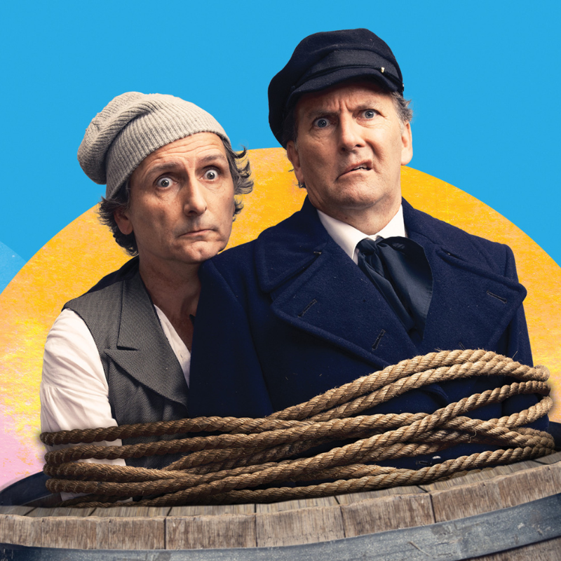 Frank Woodley & Colin Lane looking worried, bound together with a rope while standing in a barrel