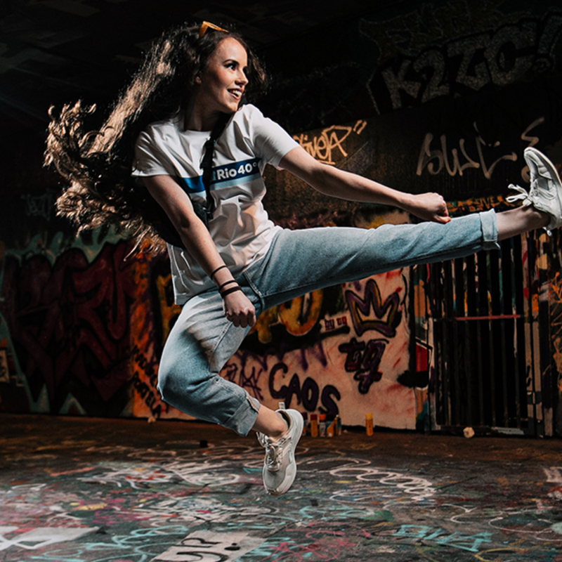 woman jumps kicking the air