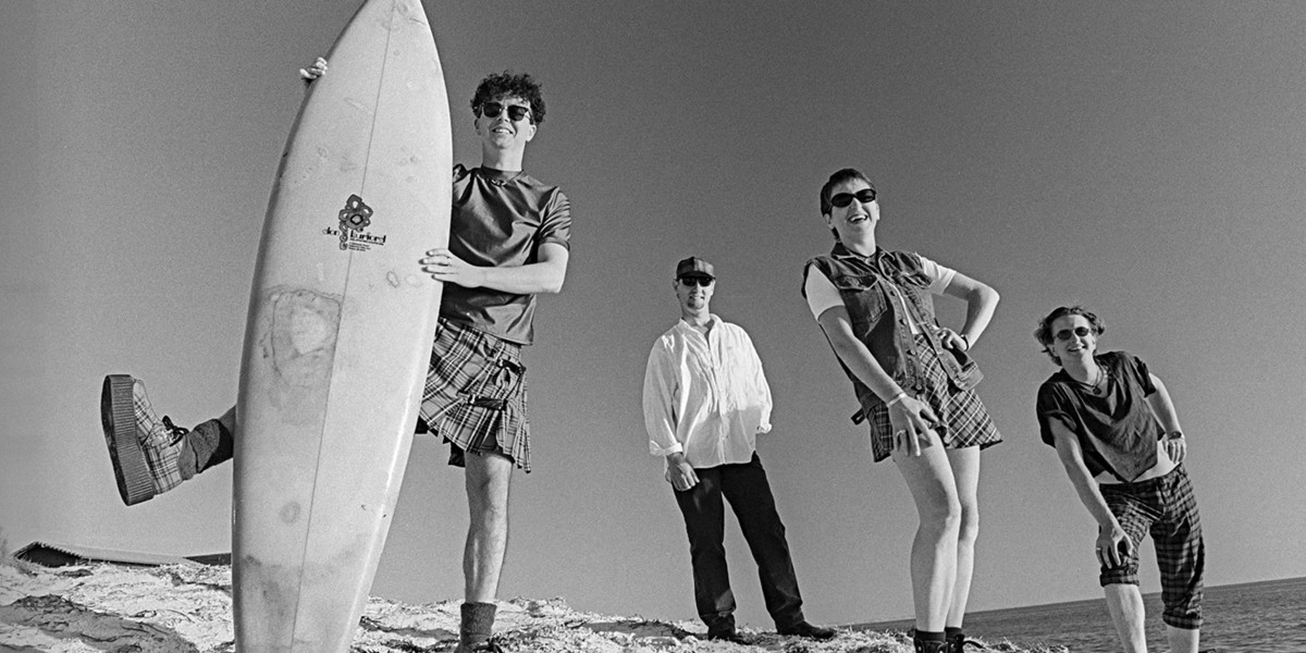 The BordererS on the beach with a surfboard circa 1994 with original members Rod Boothroyd and Jeff Algra