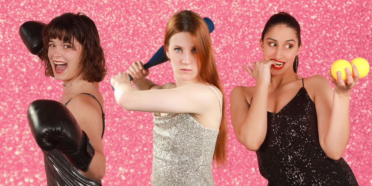 The three performers pose in front of a pink sparkly background. They are all in their sparkly, shimmery dresses and are each wearing/holding boxing gloves, a baseball bat, and balls, respectively. Nic (left) looks as if she is about to throw a punch but it won't be a very strong one, Tess (centre) is adement she will get a home run on the next hit, and Steph (right) is suggestively distracted by the balls she is holding in her hand.