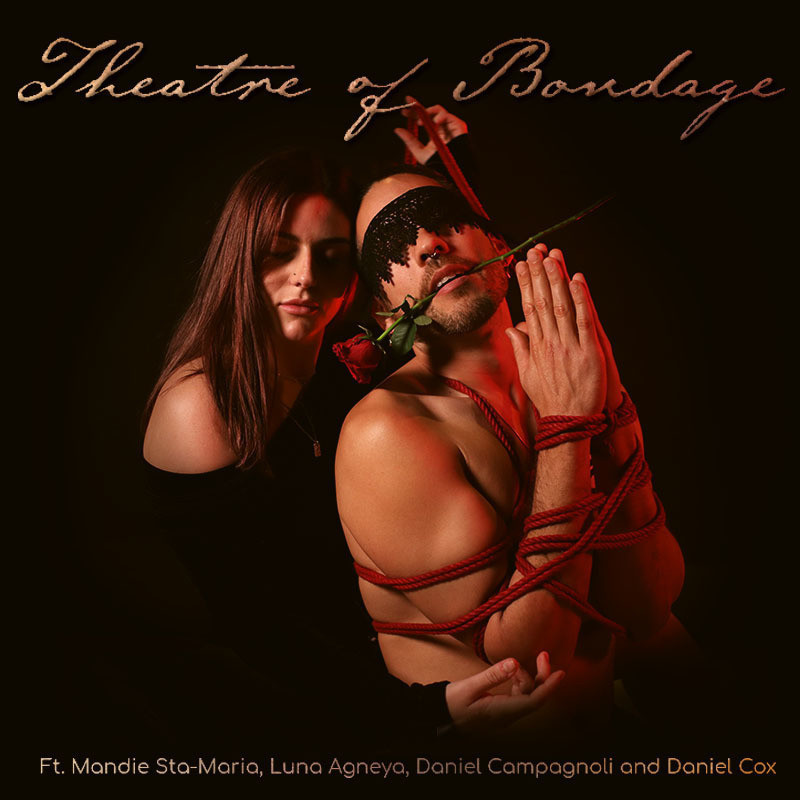 An image of a woman with her eyes closed next to a person wearing a lacy black eye mask, red rose in his mouth and his arms tied to his chest with red rope. The text on the top of the image treads ‘Theatre of Bondage’ in gold calligraphy font.