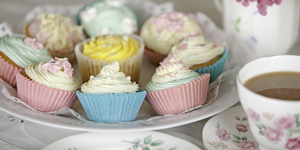 A plate of colourful cupcakes.