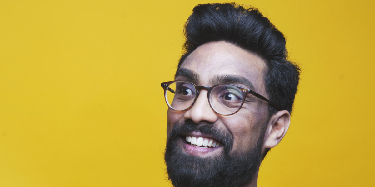 A handsome photo of Suren, joyfully looking at something off camera. He's wearing a yellow t-shirt while stood in front of a yellow background. This is testimony to both his fashion sense and ability to plan.