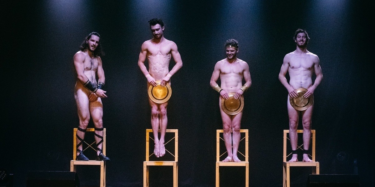 4 greek godz are naked on golden chairs One is jumping off and the others are giggling.

They all have golden plates covering their crotch. Except one. Who is awkwardly reaching for a plate.
