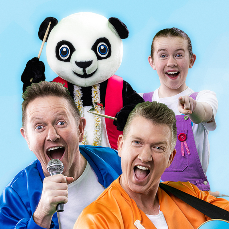 The Mik Maks: Songs to Help Us Grow - One person in a panda costume, one man holding a mircrophone and one man playing a guitar, one young teenage girl. Everyone is smiling.