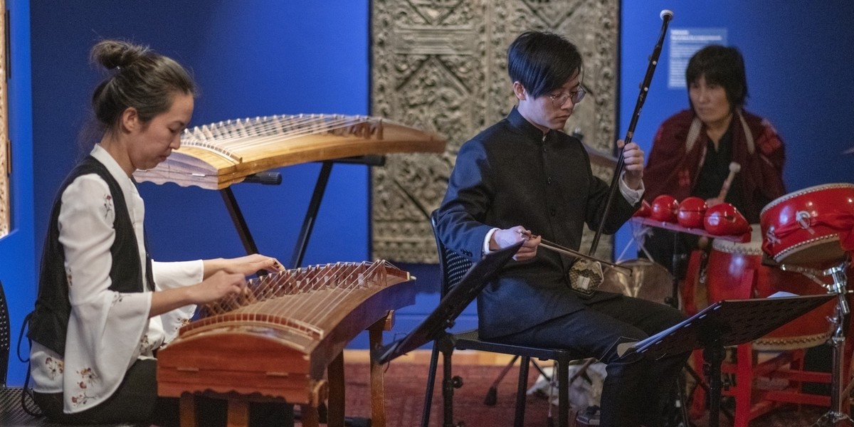 Zhao playing the Guzheng (Chinese harp), David playing Erhu, Satomi playing Woodblocks and Chinese drums at the Art Gallery of South Australia.