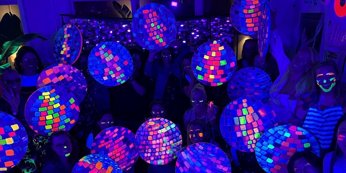 GLOW! A 90's UV ART PARTY - Large group holding up there disco ball paintings