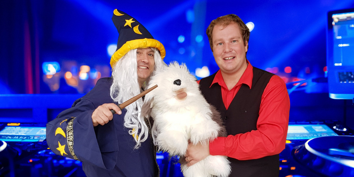 Tony is dressed as The Wizard and Scott is holding Digger Dog as they pose after a theatre show