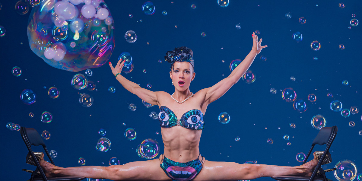 woman doing the splits surrounded by bubbles in her underwear