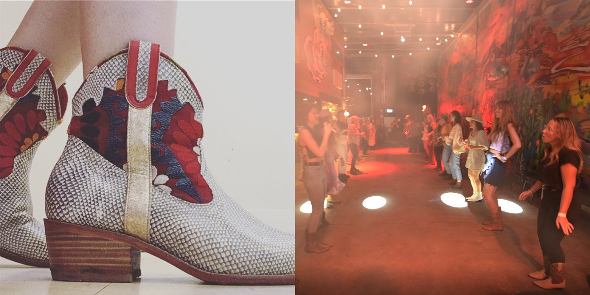A red boot set next to people line dancing in a bar.
