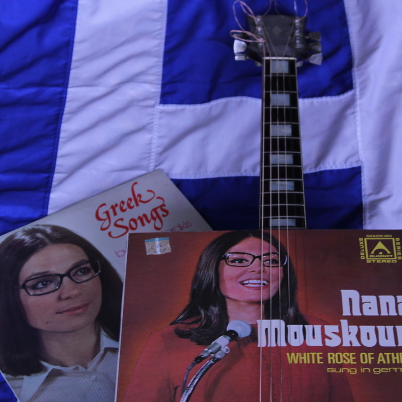 NANA MOUSKOURI – LIFE AND SONGS – OVER 2500 SHOWS IN LONDON WITH LOUCAS LOIZOU - An image of two Nana Mouskouri album covers and the strings of a musical instrument on a Greek flag.