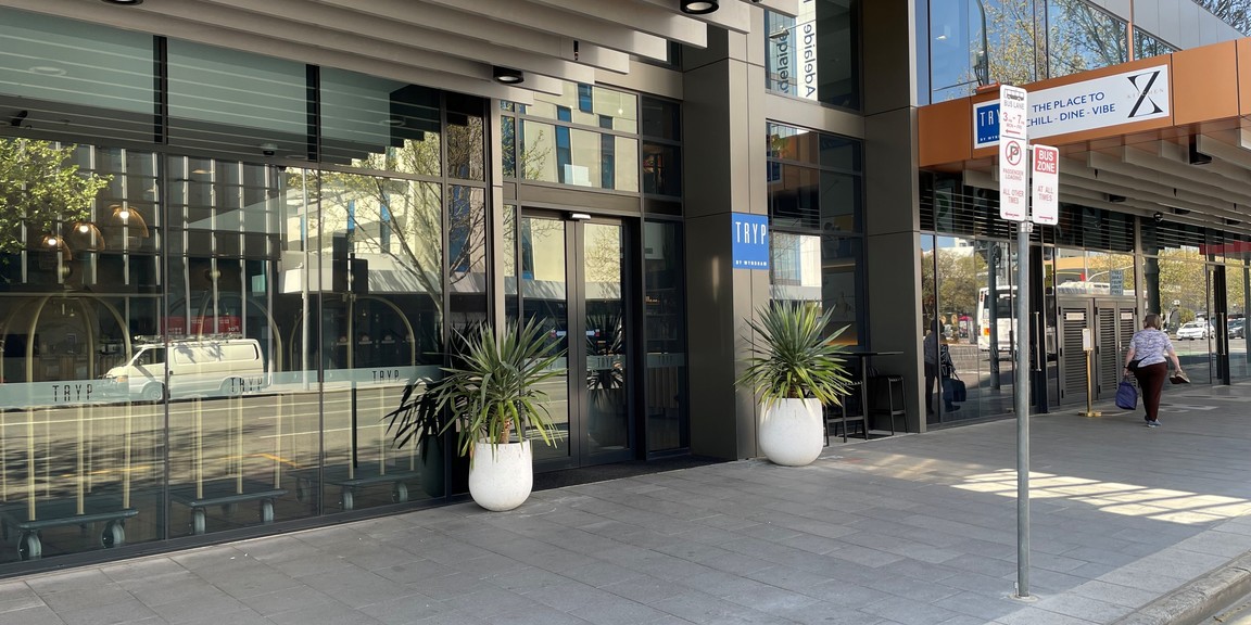 Drop off point immediately outside the main entrance of the hotel at 266 Pulteney Street. Showing loading zone sign, clear path from curb to doorway and doorway to the hotel with TRYP by Wyndham signage