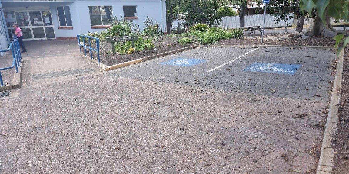 2 parking spaces adjacent to a garden and a ramp to front entrance