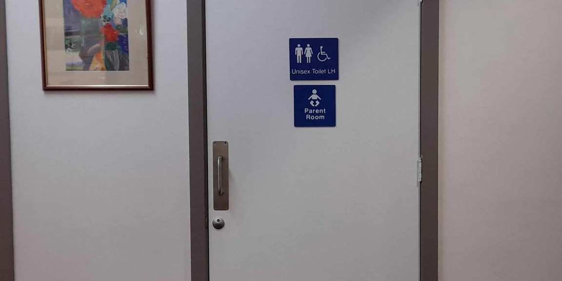Unisex accessible toilet door located midway along front hallway at Fullarton Park Community Centre